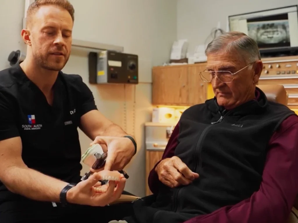 Dr. Matthysse discussing implants and treatment with happy patient in Austin, TX