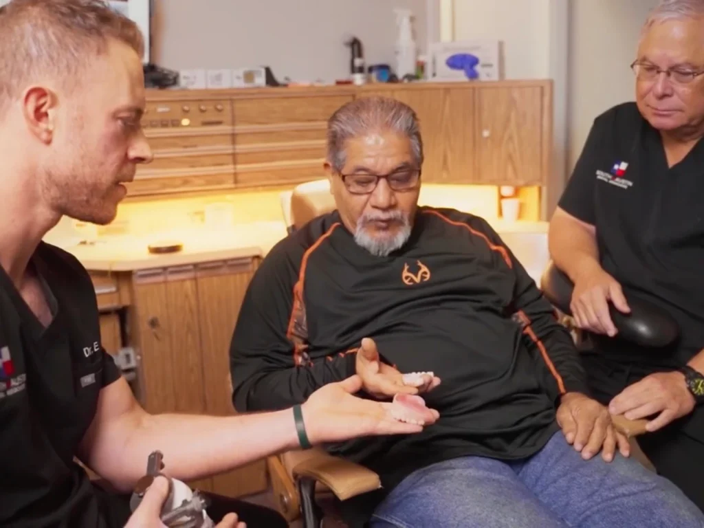 Dr. Matthysse discussing implants with happy patient in Austin, TX