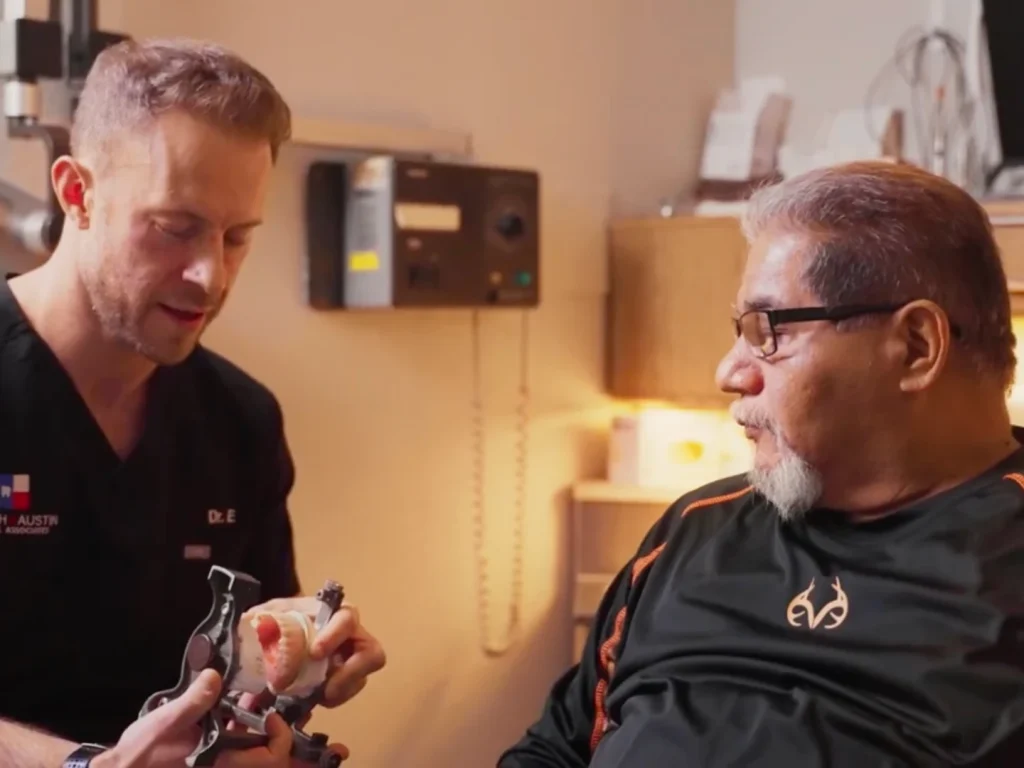 Dr. Matthysse discussing implants with happy patient in Austin, TX